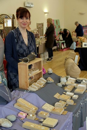 Picture of jewellery maker Sarah Jane Lewis standing in front of her stall at a previous Collective Art in Marlow event